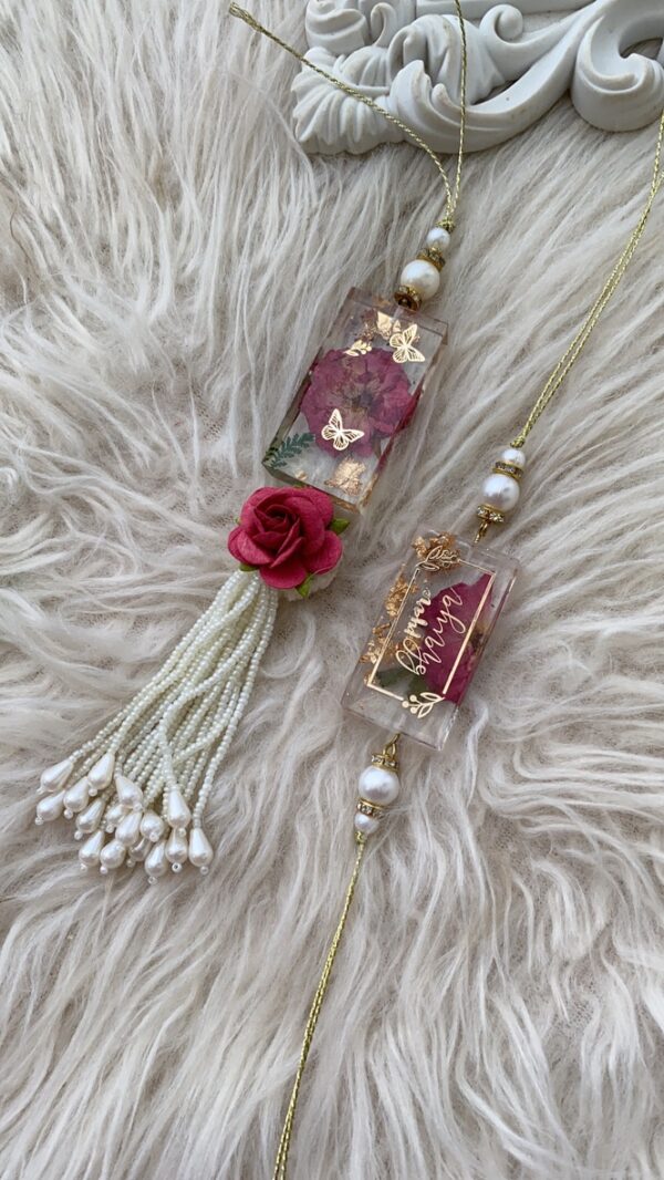 Enchanted-(real rose resin rakhi and lumbi pair)